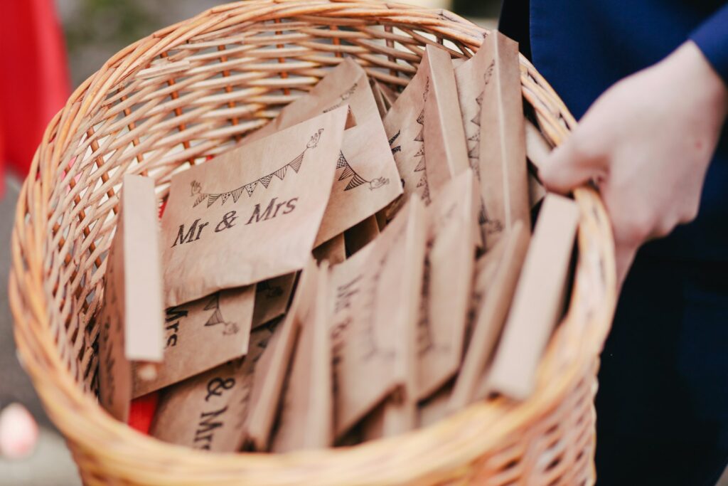 Hände halten Umschläge mit der Aufschrift Mr und Mrs für ein Geldgeschenk zur Hochzeit